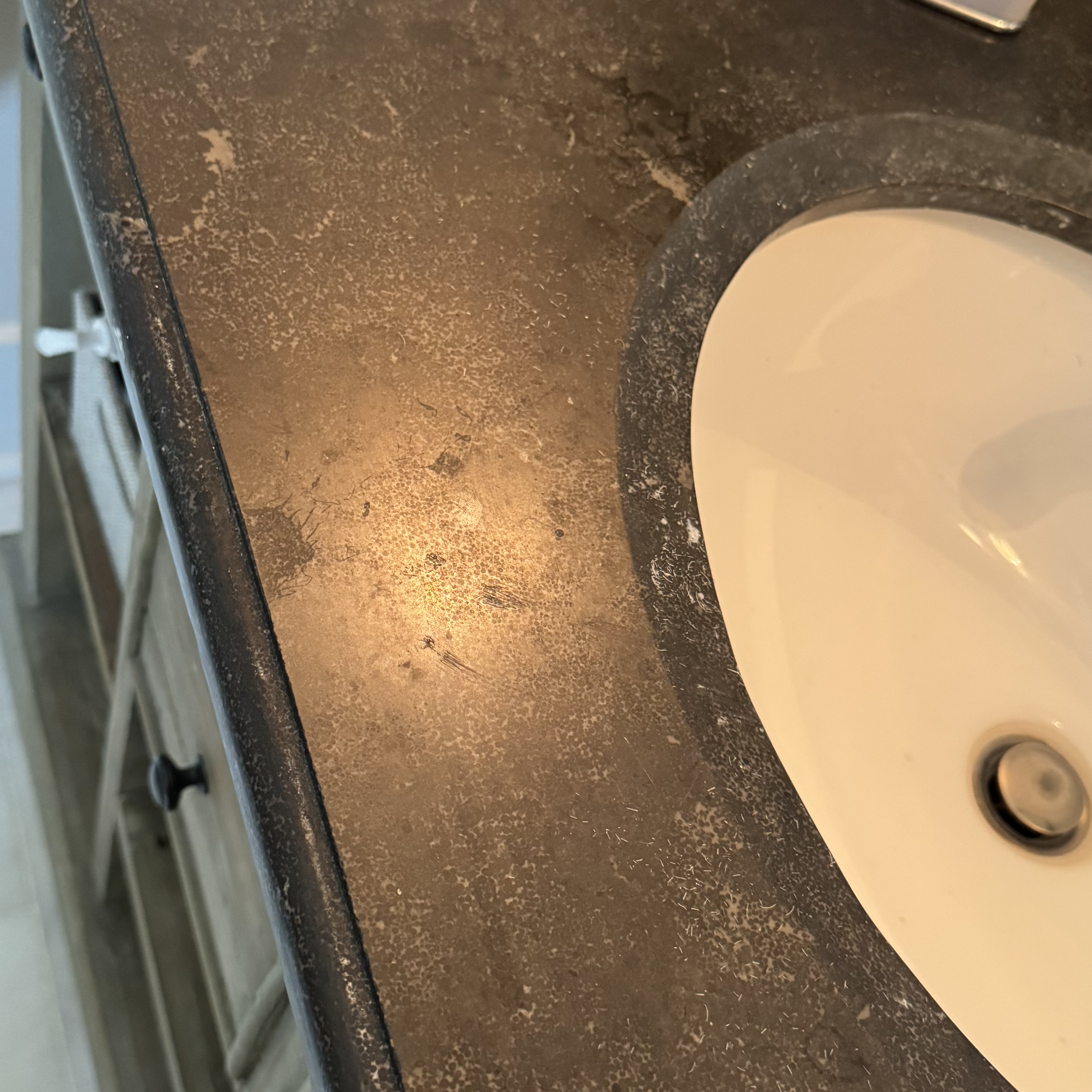 Etched marble surface with dull white spot